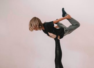 Mother And Daughter Doing Yoga Together