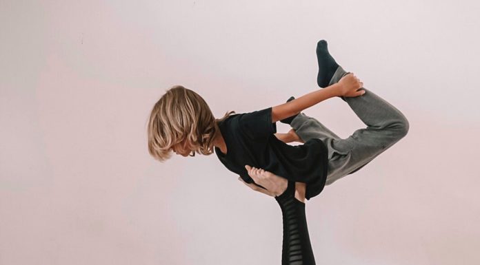 Mother And Daughter Doing Yoga Together